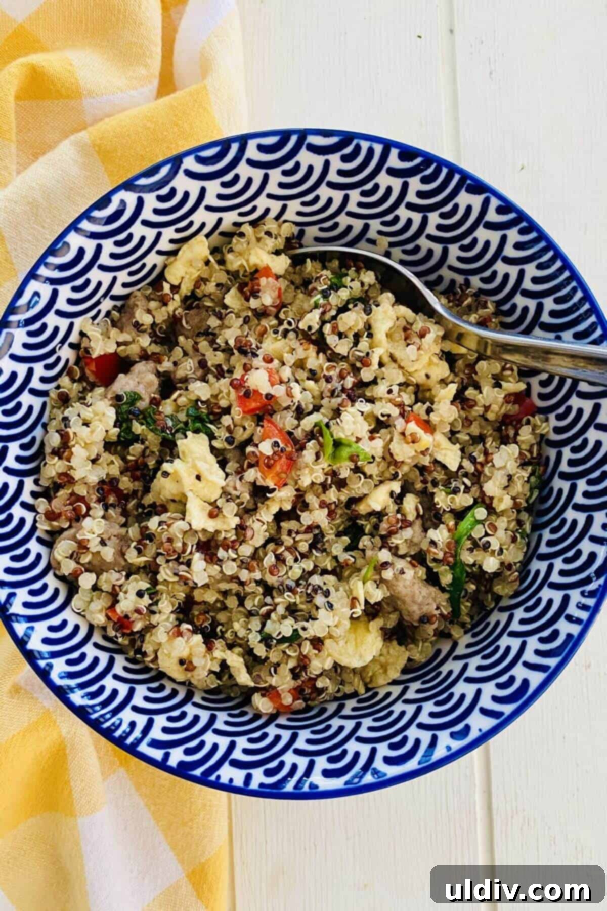 The Savory Quinoa Kickstart: Eggs, Sausage & Spinach 2 A quinoa breakfast bowl with eggs, bell peppers and spinach.