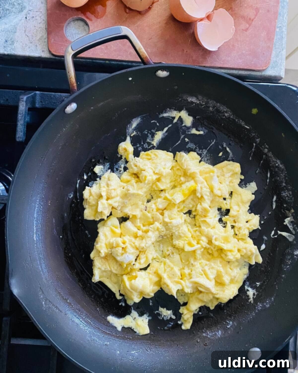 The Savory Quinoa Kickstart: Eggs, Sausage & Spinach 7 Scrambled eggs in a pan.