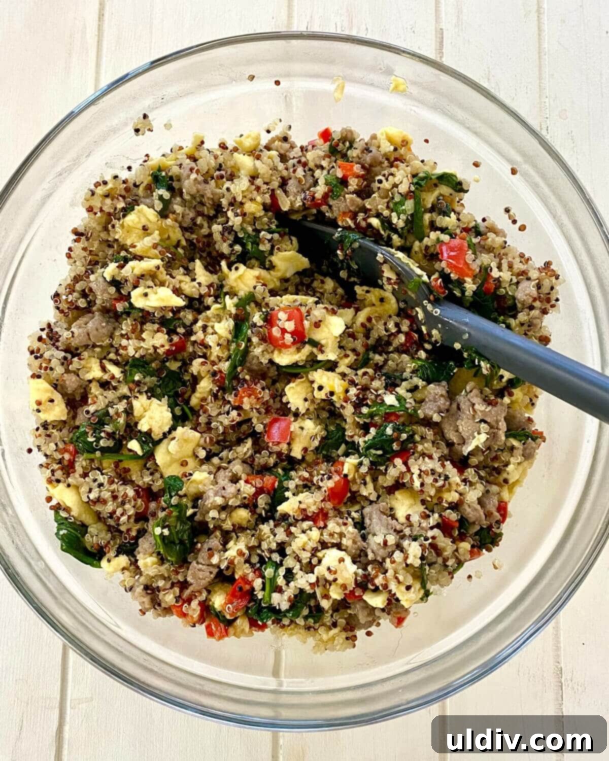 Fuel Your Morning: Savory Quinoa Bowl with Eggs, Sausage & Spinach 8 A completed savory quinoa breakfast bowl, stirred together and ready to be served warm.