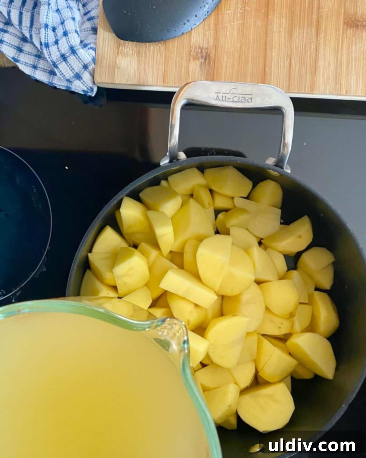 30-Minute Easy Cheesy Ham and Potato Soup 4 cubed potatoes in a pot and adding chicken stock.