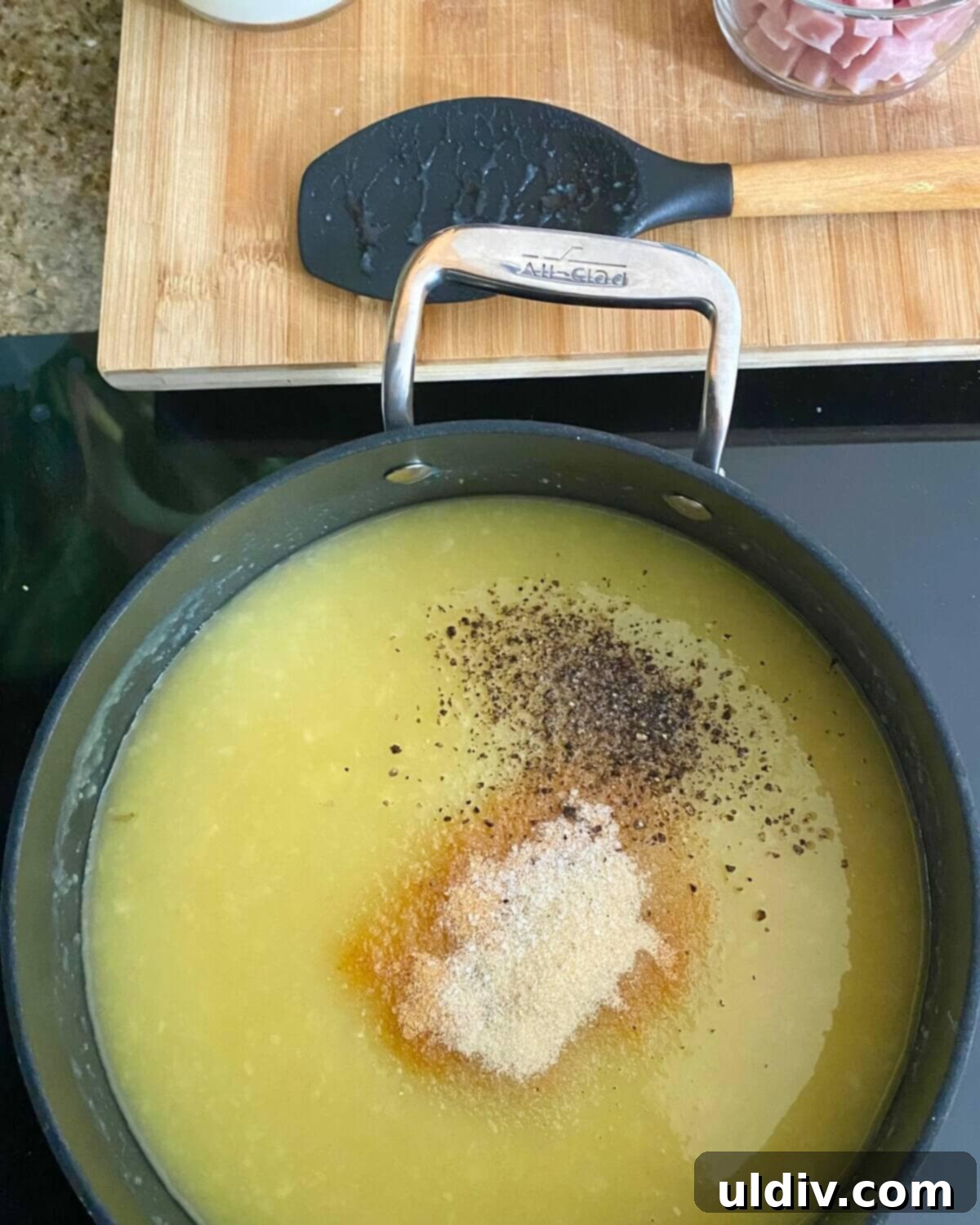 30-Minute Easy Cheesy Ham and Potato Soup 5 adding seasonings to soup.