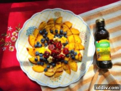 Ponti: A Culinary Symphony of Heritage and Future 6 A refreshing fruit salad generously drizzled with Ponti organic balsamic glaze, highlighting its creamy texture.