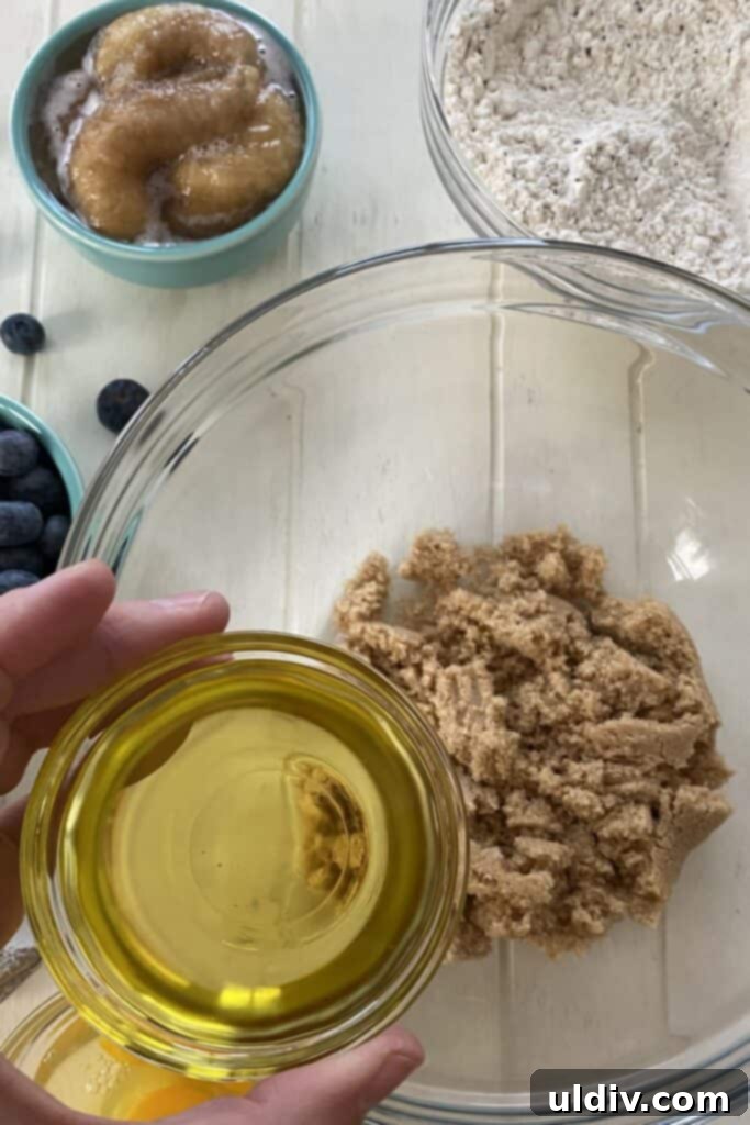 Mediterranean Olive Oil Banana & Blueberry Loaf 5 adding olive oil to light brown sugar.
