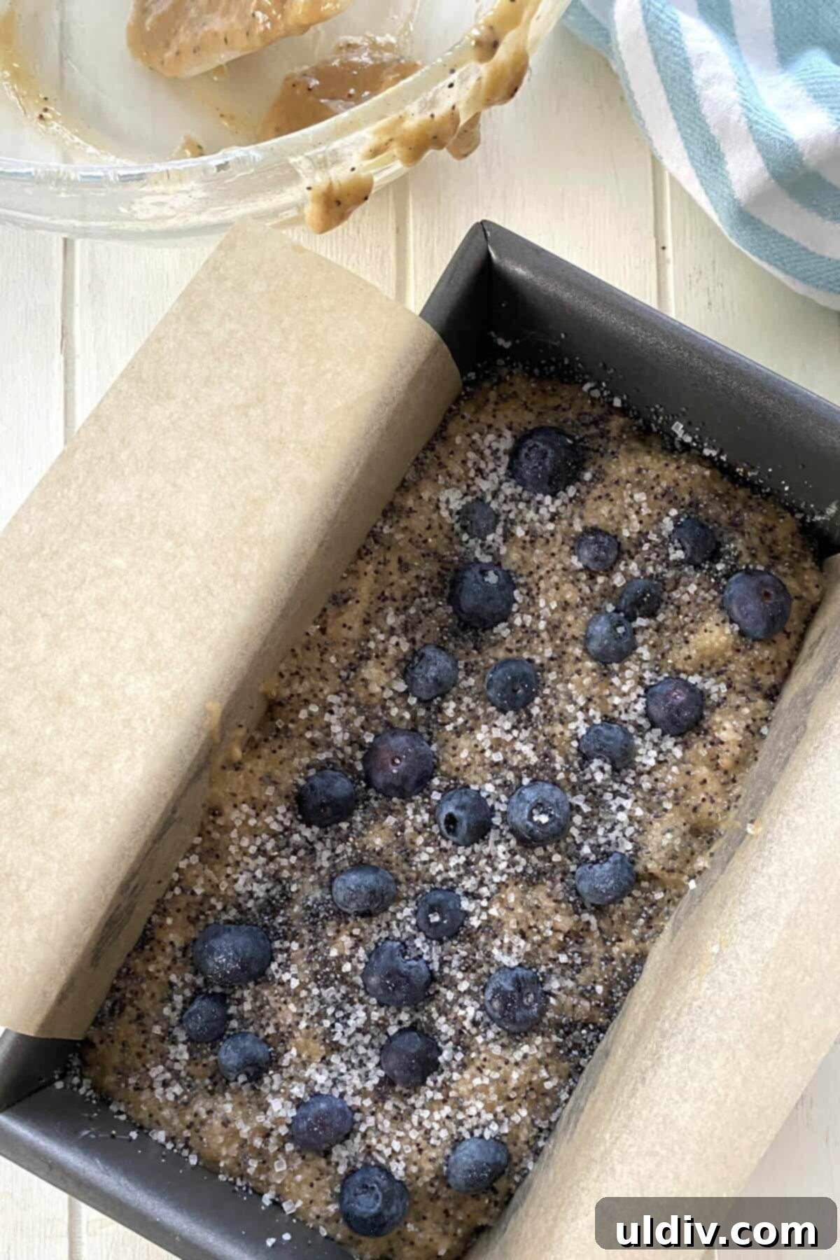 Mediterranean Olive Oil Banana & Blueberry Loaf 7 olive oil banana bread batter in a metal loaf pan.