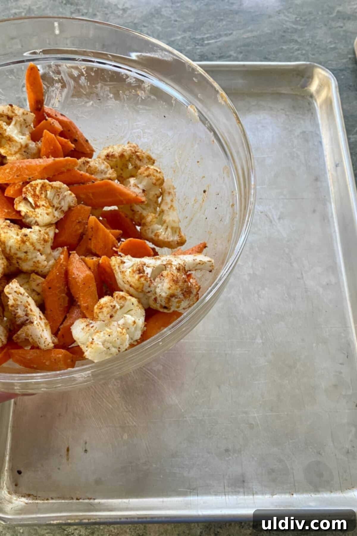 Honey-Glazed Roasted Carrots and Cauliflower with Tangy Goat Cheese 5 Spreading seasoned carrots and cauliflower onto a hot baking sheet.