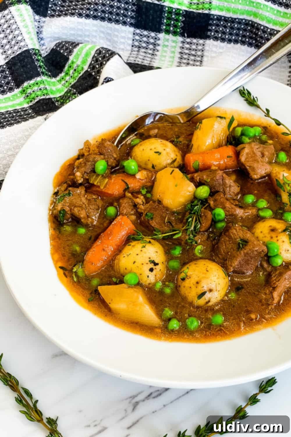 Hearty Guinness Lamb Stew 3 Close-up of a rustic bowl filled with Irish Lamb Stew, showcasing tender lamb, carrots, potatoes, and a rich Guinness gravy