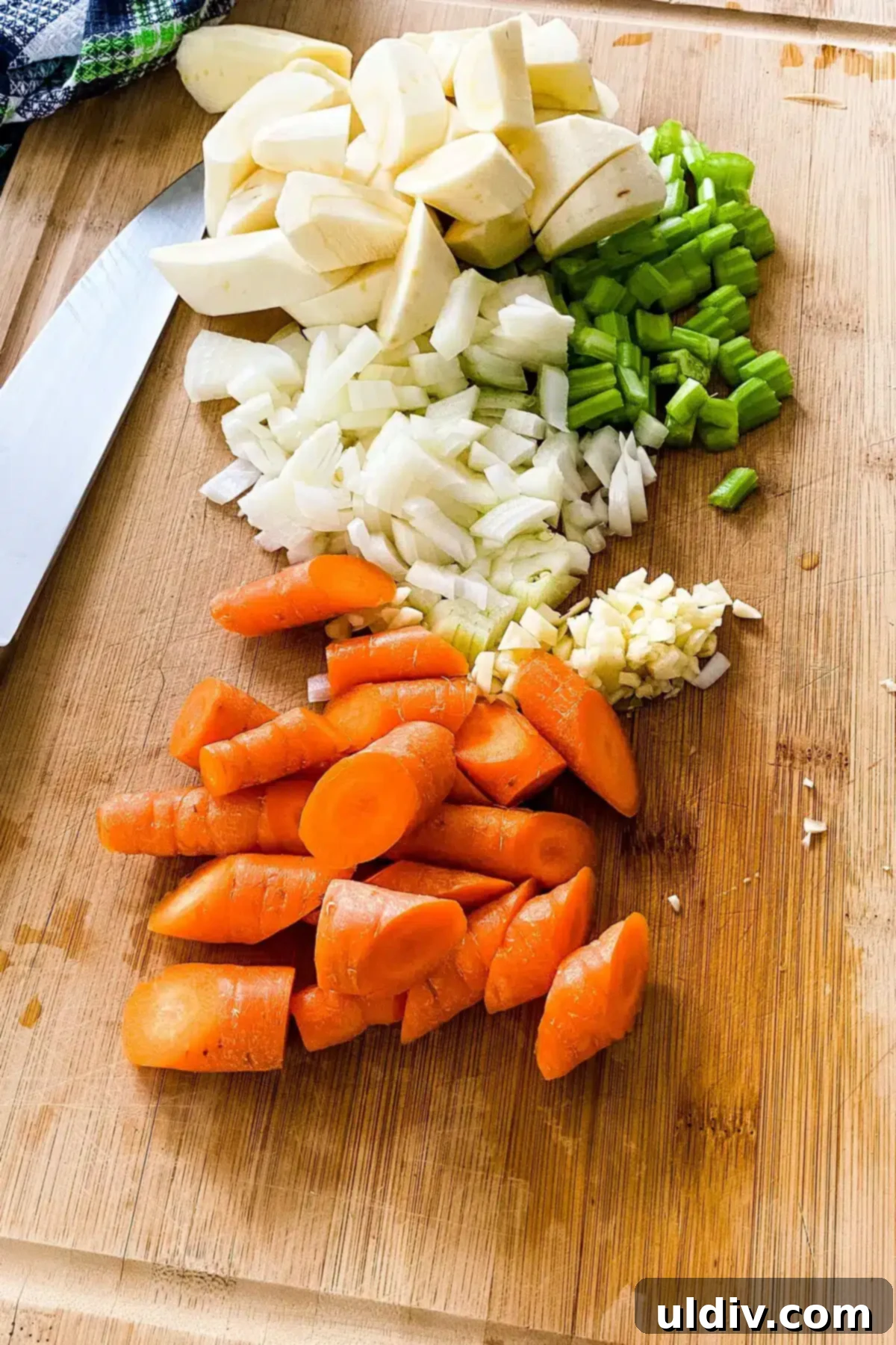 Traditional Irish Lamb Stew with a Guinness Kick 5 Finely chopped carrots, parsnips, onions, and celery laid out on a cutting board, ready for the Irish lamb stew with Guinness.