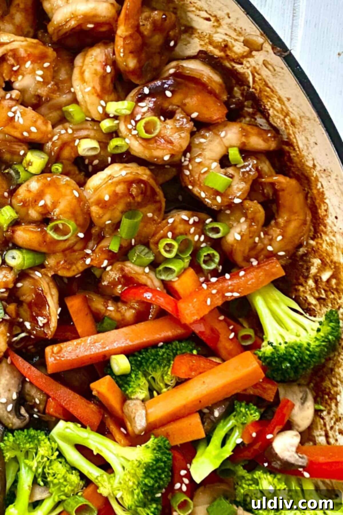 hibachi shrimp, mushrooms, broccoli and carrots in a pan.