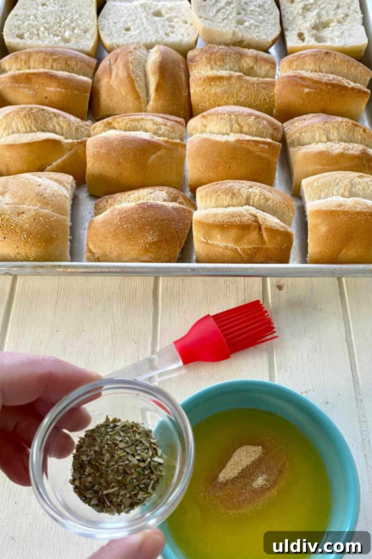 Bite-Sized Chicken Parm Sliders 6 Dried oregano and basil being added to melted butter in a small white bowl, ready to be mixed into a fragrant herb butter.