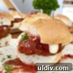 Bite-Sized Chicken Parm Sliders 10 Small chicken sandwich with melted cheese and basil.