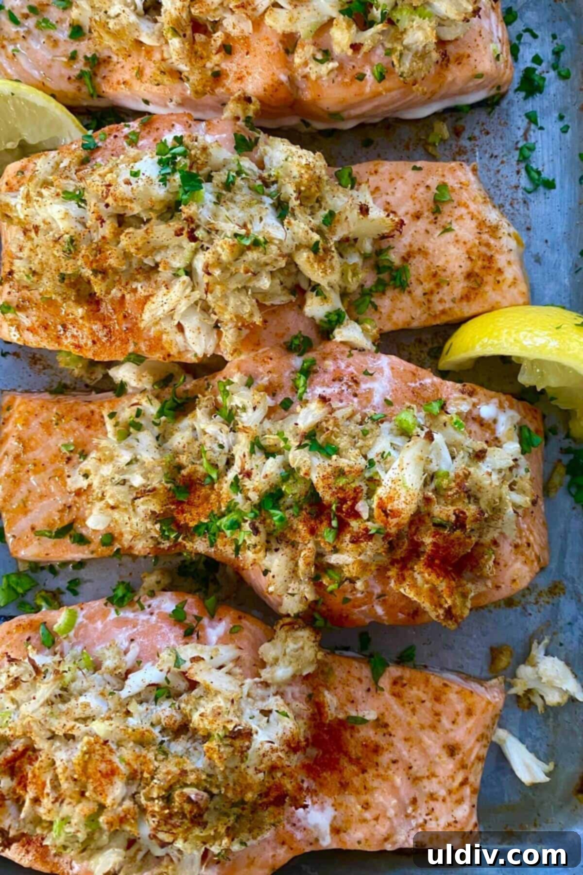 Regal Salmon Crab Delight 2 Baked crab stuffed salmon on a baking sheet, ready to serve.