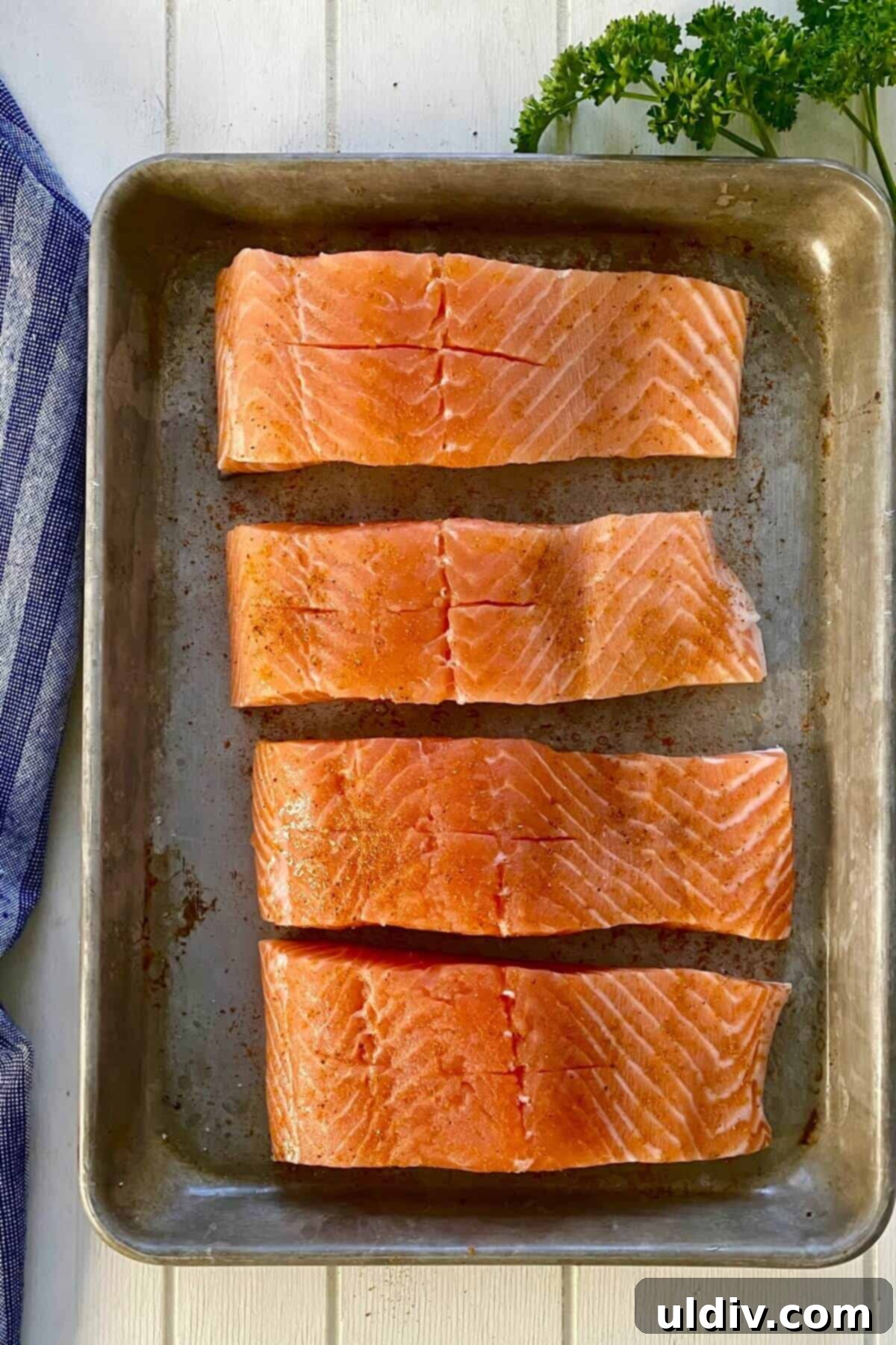 Regal Salmon Crab Delight 4 Four salmon fillets with pockets cut into them, ready for stuffing.