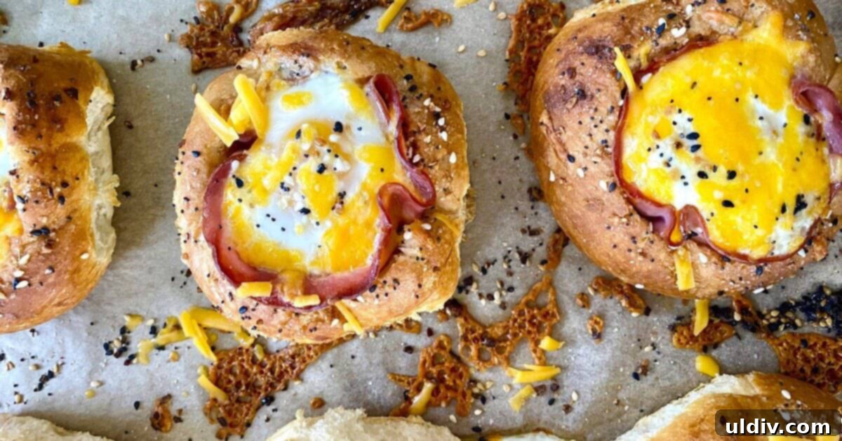 Ham and Egg Bread Bowls 4 Several bread bowls filled with golden-baked ham, melted cheese, and perfectly set eggs, ready to be served.