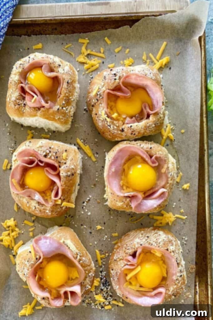 Ham and Egg Bread Bowls 8 Bread bowls meticulously filled with ham, cheese, and a freshly cracked egg, topped with more cheese and seasoning.