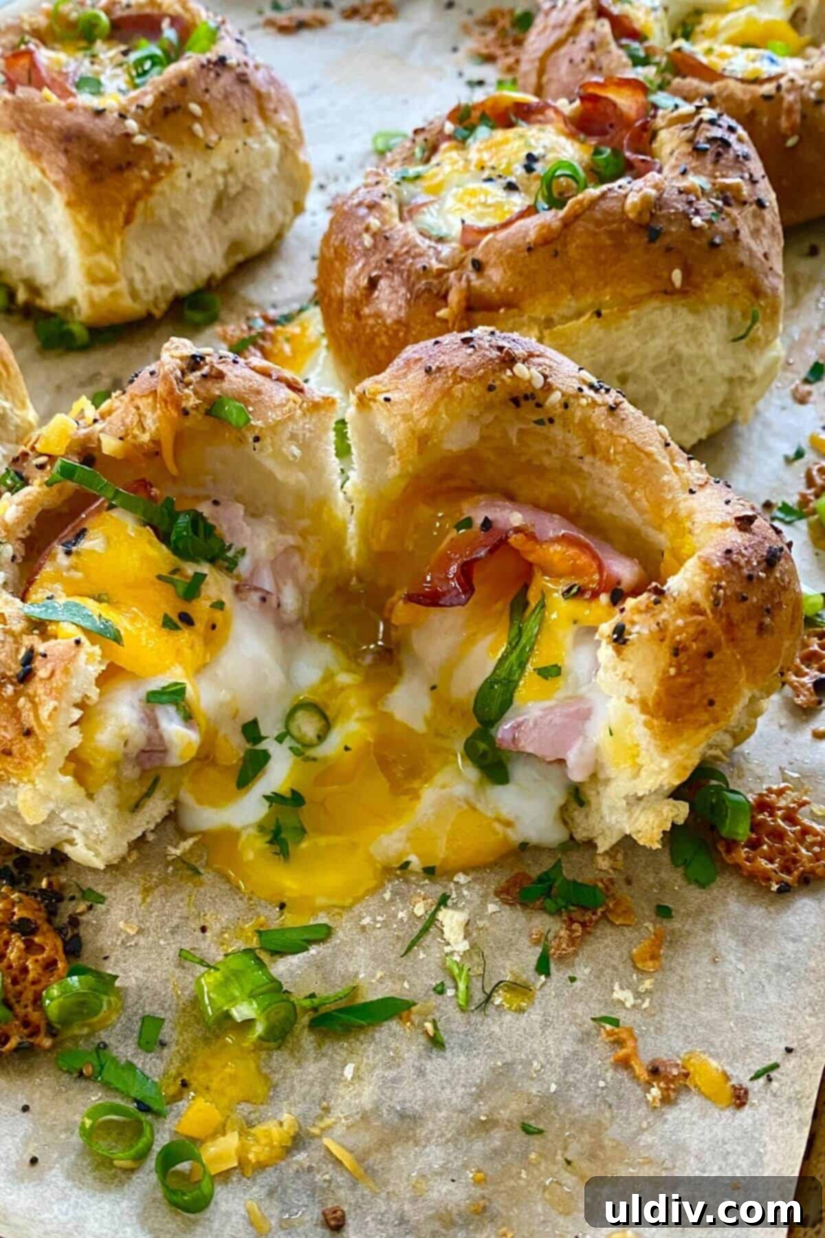 Ham and Egg Bread Bowls 9 A close-up of a Ham and Egg Sandwich Bread Bowl with a perfectly runny yolk, garnished with fresh scallions.