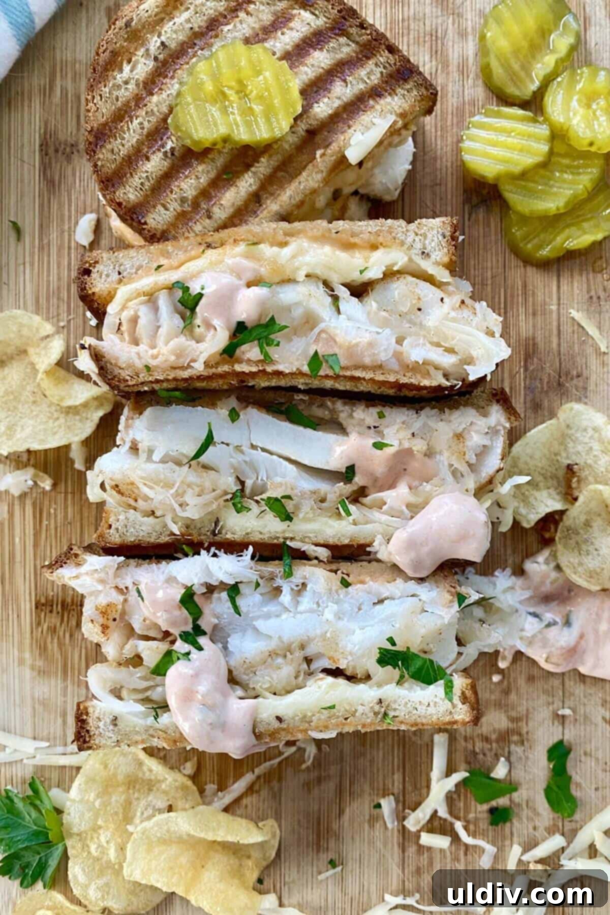 Wild Cod Reuben: Dressed in 30 Seconds 11 Three halves of a perfectly toasted fish reuben sandwich, showcasing its delicious layers and crispy exterior.