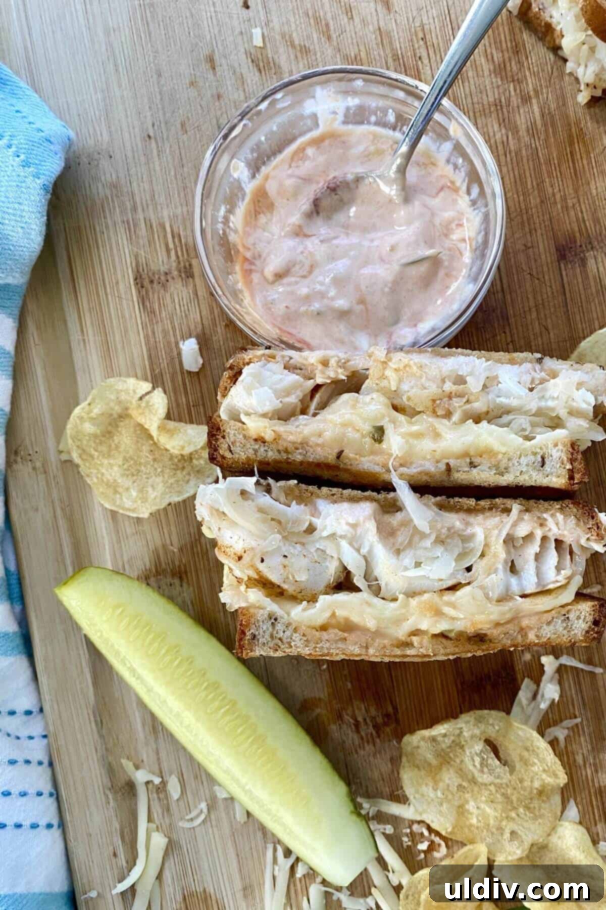 Wild Cod Reuben Sandwich with Zesty 30-Second Russian Dressing 3 A cod fish reuben sandwich with a bowl of dressing.