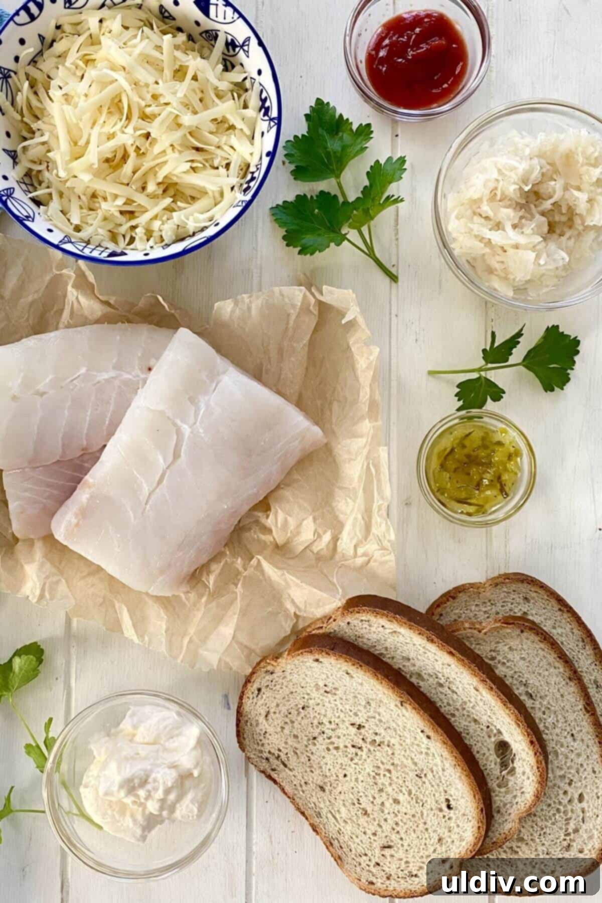 Wild Cod Reuben Sandwich with Zesty 30-Second Russian Dressing 4 Wild cod, rye bread, mayonnaise, Swiss cheese, sauerkraut on a wood counter.