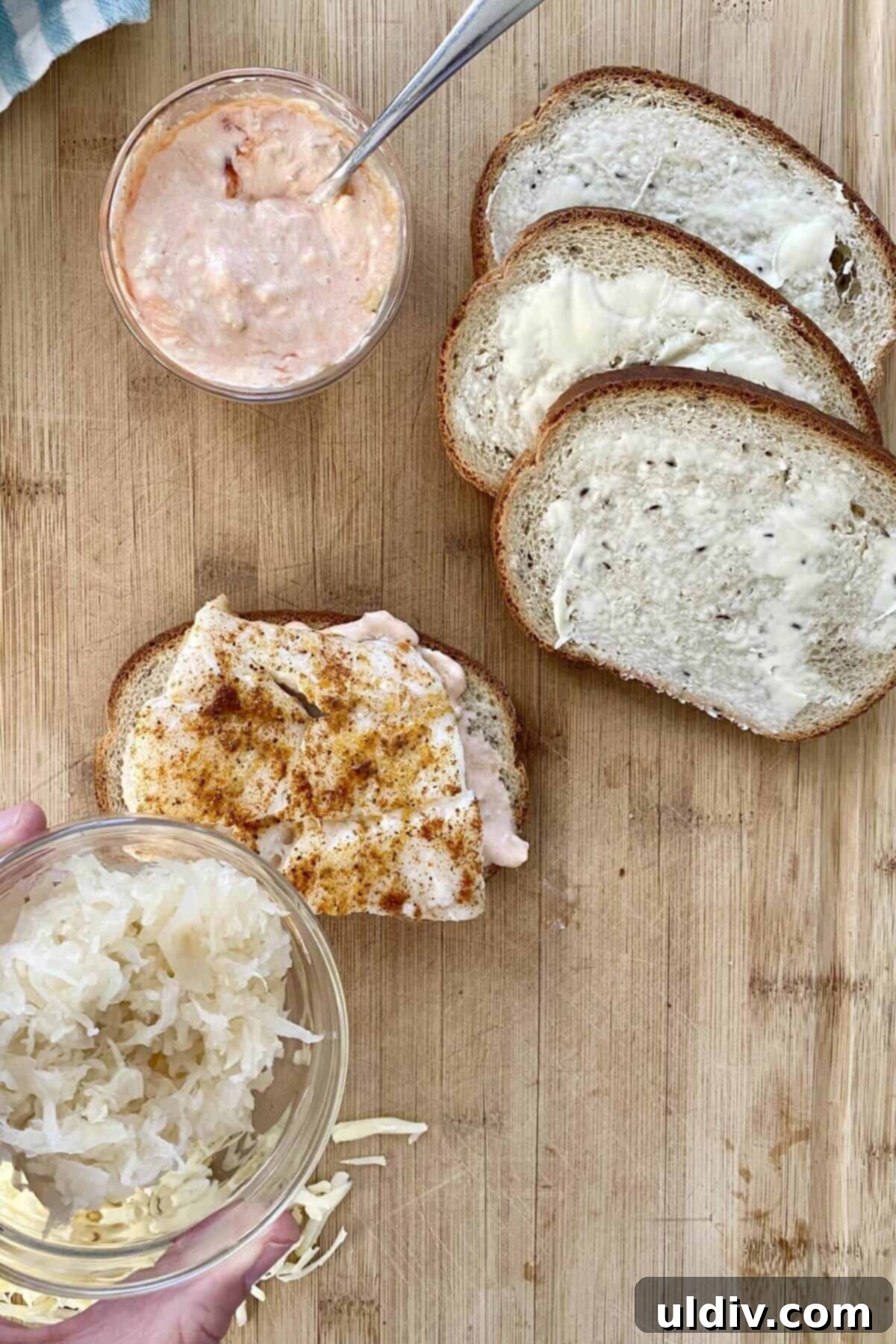 Wild Cod Reuben: Dressed in 30 Seconds 8 A perfectly cooked piece of cod resting on a slice of rye bread, ready for the next layers of the reuben sandwich.