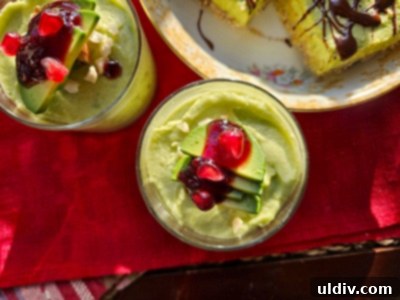 2024's Easiest Super Bowl Snacks 8 Delicious avocado and chocolate bars with an oat crust, topped with a rich green avocado cream and chocolate drizzle, presented on a platter.