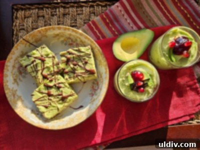 2024's Easiest Super Bowl Snacks 9 Close-up of a serving of avocado chocolate mousse in a glass, garnished with melted dark chocolate, pomegranate arils, and chopped peanuts.