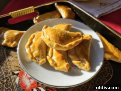 Close-up of baked Cantonese Sweet Dumplings (Gok Zai) with intricate patterns
