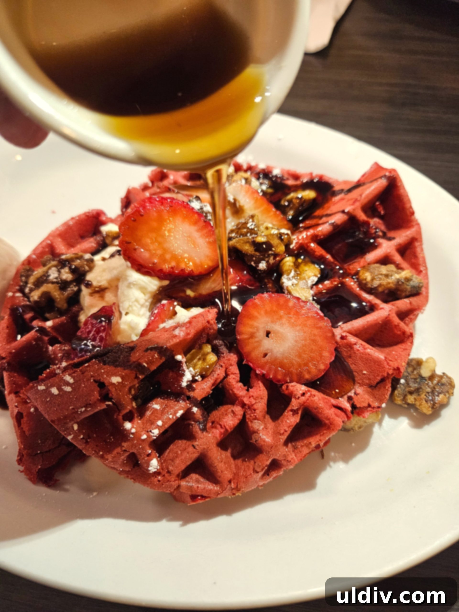 Chicago Waffles: A Delightful Brunch for Women's Day Weekend 2 A delicious waffle, possibly Red Velvet, with cream, strawberries, and walnuts, setting the tone for a delightful brunch experience at Chicago Waffles.