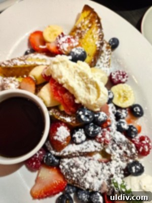 A French toast flight from Chicago Waffles, featuring Very Berry, Cinnamon Swirl, and Red Velvet French toasts, beautifully arranged for a diverse tasting experience.