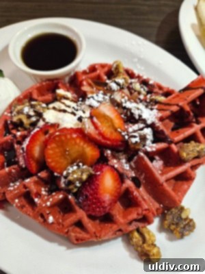 Chicago Waffles: A Delightful Brunch for Women's Day Weekend 6 The exquisite Red Velvet waffle from Chicago Waffles, topped with vanilla cream cheese, fresh strawberries, candied walnuts, and chocolate sauce.