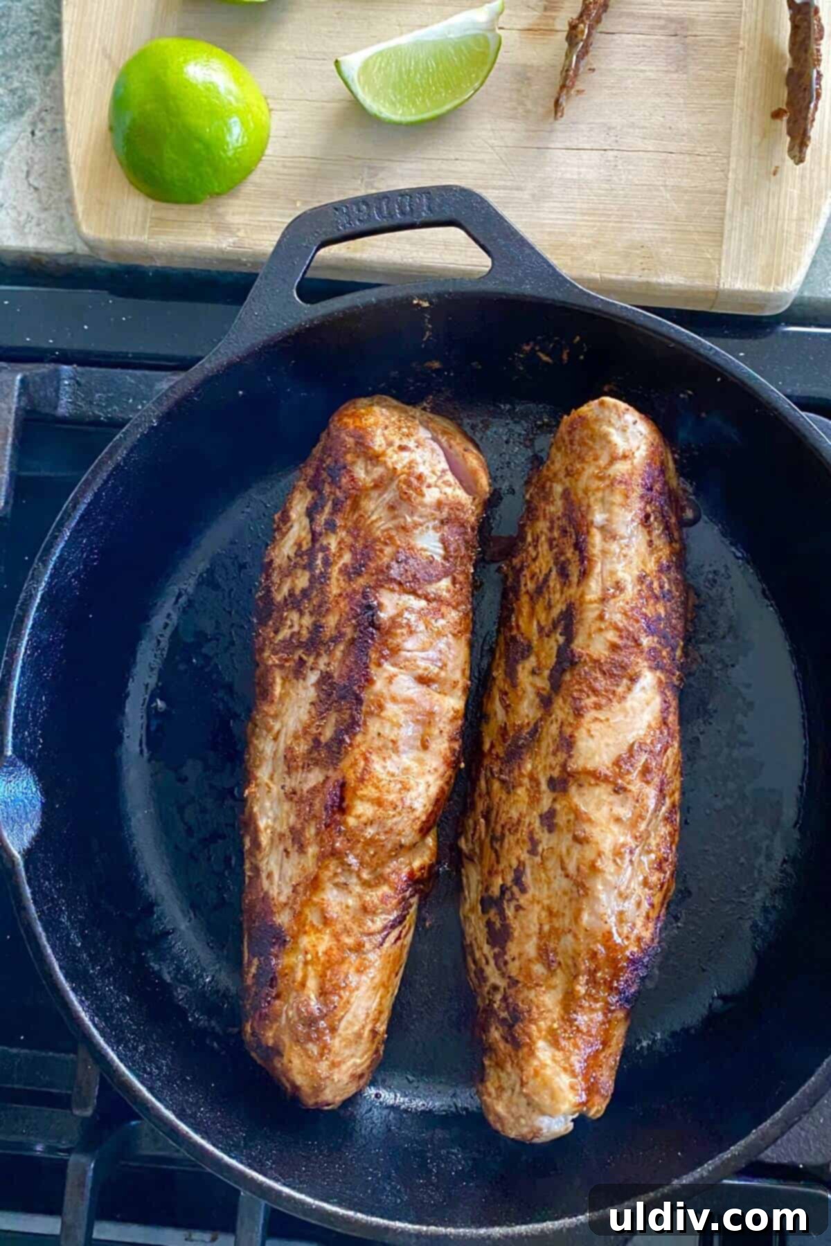 Tropical Tango Pork Tenderloin with Mango Salsa 5 A seasoned pork tenderloin searing to a beautiful golden brown in a hot cast iron skillet, creating a delicious crust.