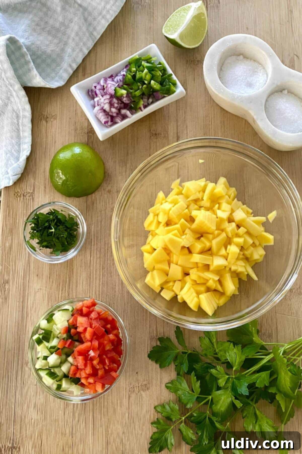 Tropical Heat Pork Tenderloin 6 Mango, chopped red pepper, jalapeno, lime on a cutting board.