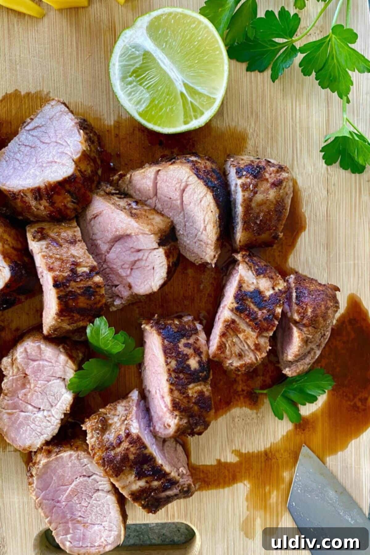 Tropical Heat Pork Tenderloin 8 A sliced pork tenderloin on a cutting board.