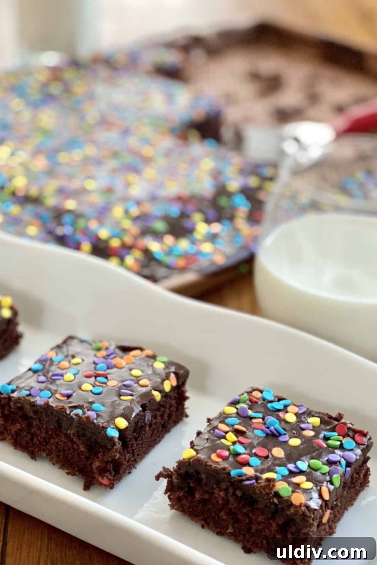 A large Texas Sheet Cake with a refreshing glass of milk, inviting guests to enjoy.