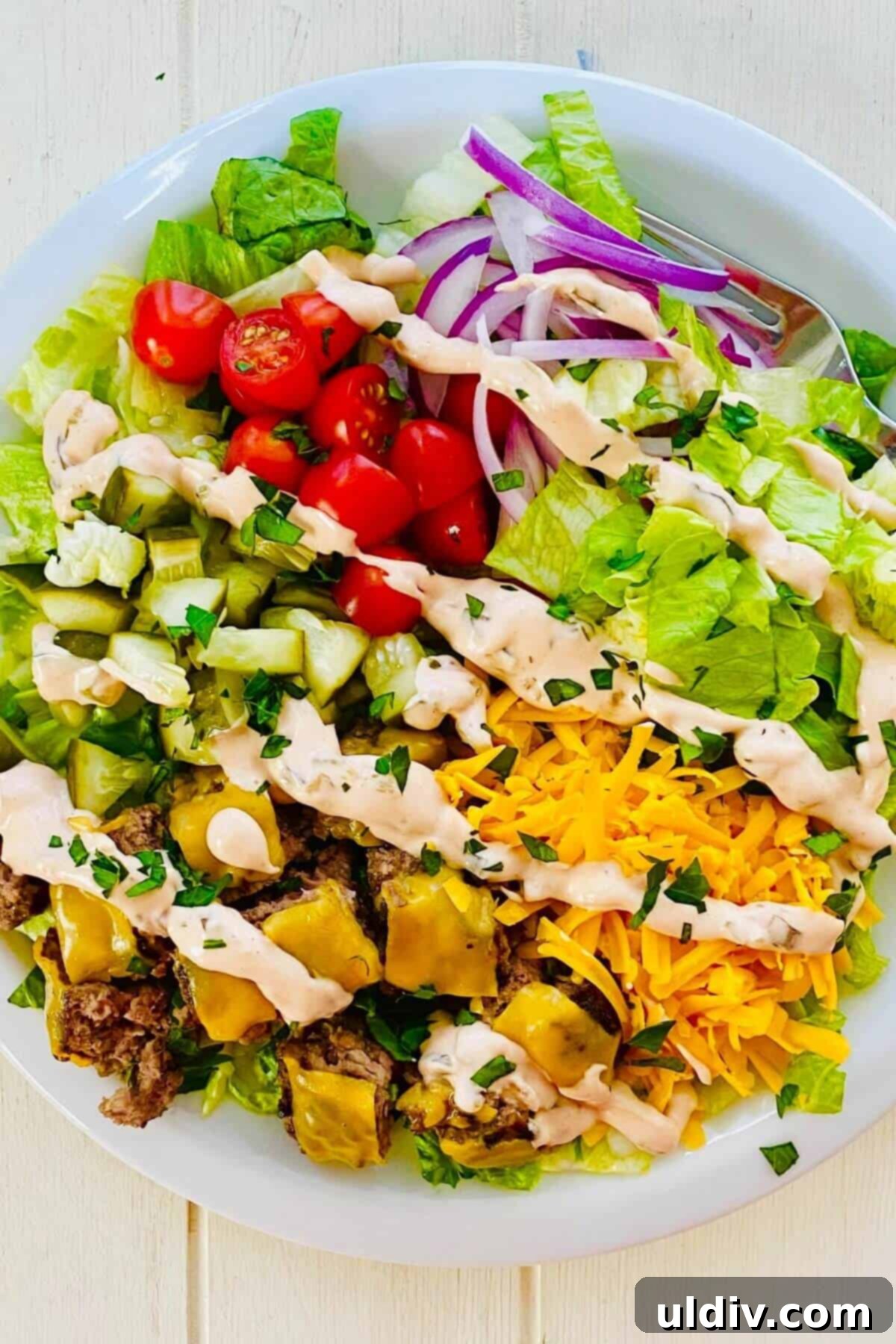 Loaded Big Mac Bowl 2 A beautifully composed Big Mac bowl, showcasing layers of fresh ingredients and juicy burger bites, drizzled with special sauce.