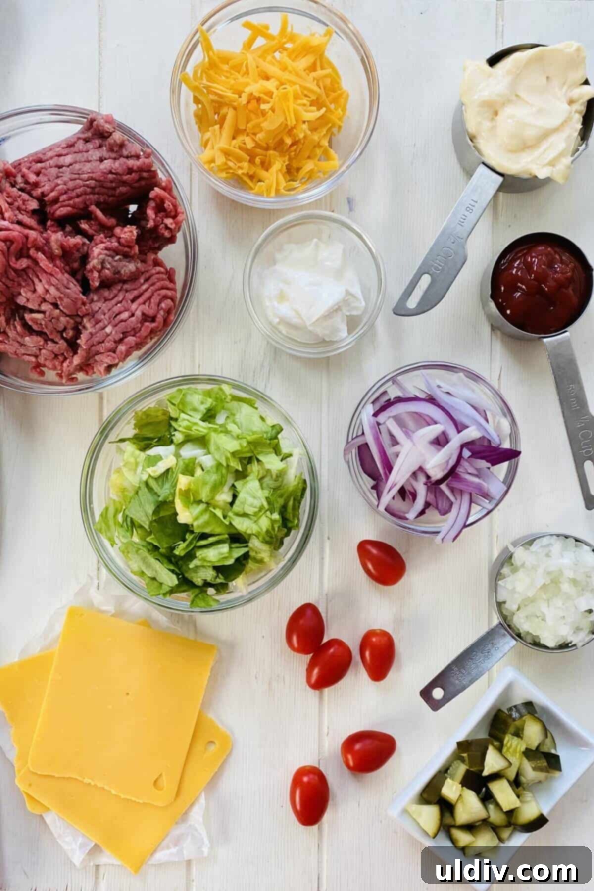 Signature Big Mac Bowl 3 A vibrant selection of ingredients for Big Mac Bowl: ground beef, fresh lettuce, cheese, onion, ripe tomatoes, ketchup, and mayonnaise.