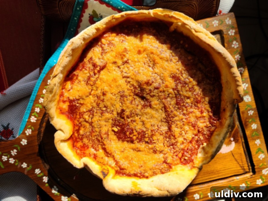 Deep Dive into Chicago Deep Dish 3 A freshly baked Chicago deep dish pizza, showing its thick crust and bubbling tomato sauce, ready to be served.