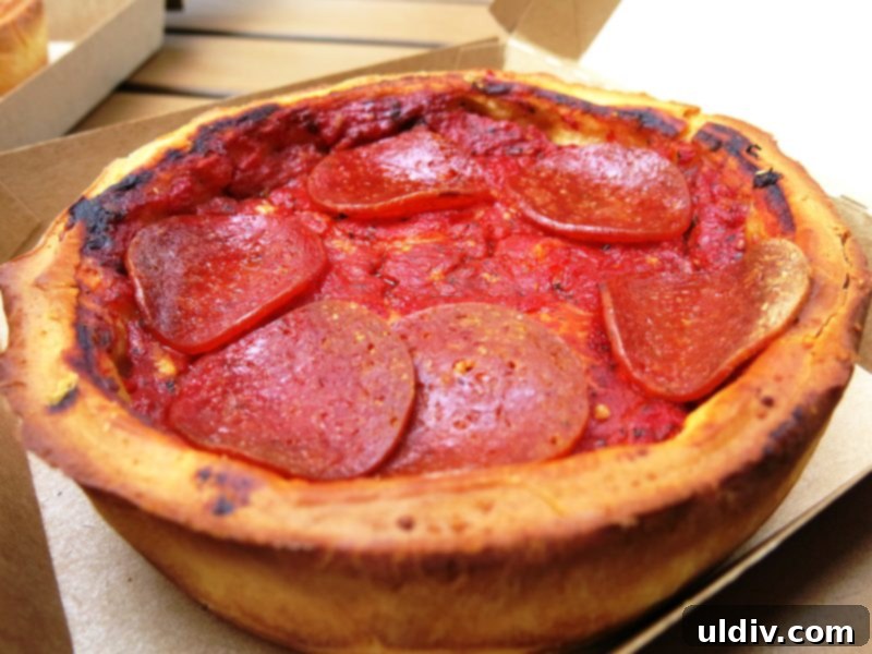 Deep Dive into Chicago Deep Dish 4 A delicious close-up of a Giordano's stuffed deep dish pizza, showcasing its rich, layered interior and golden crust.