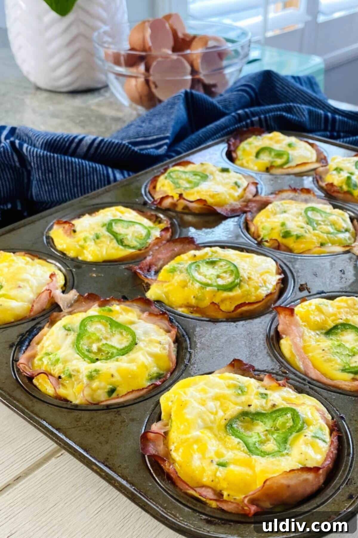 Fiery Popper Breakfast Bites 2 jalapeno egg cups in a muffin pan.