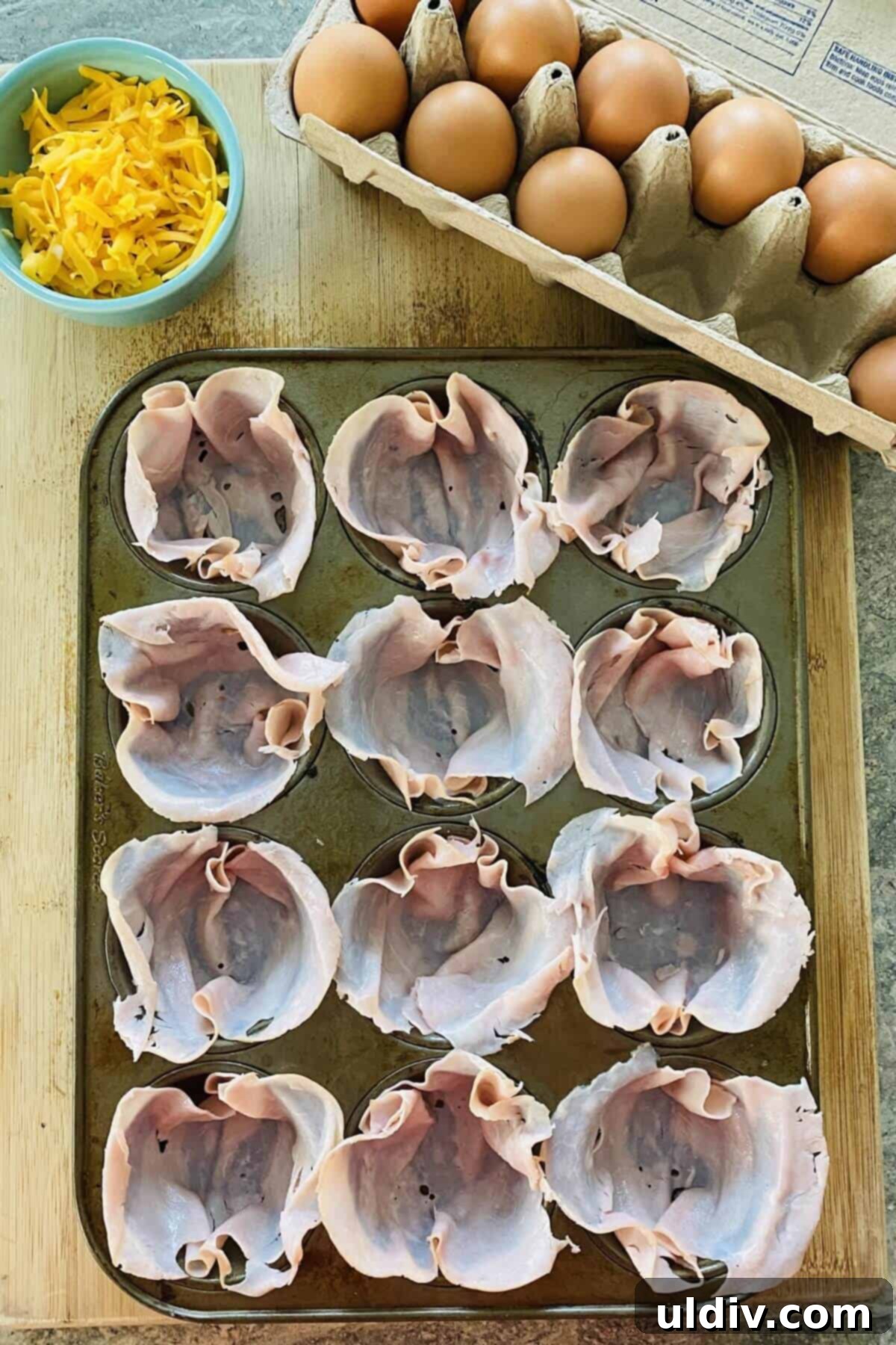 Cheesy Jalapeno Egg Popper Bites 4 ham in a muffin pan.