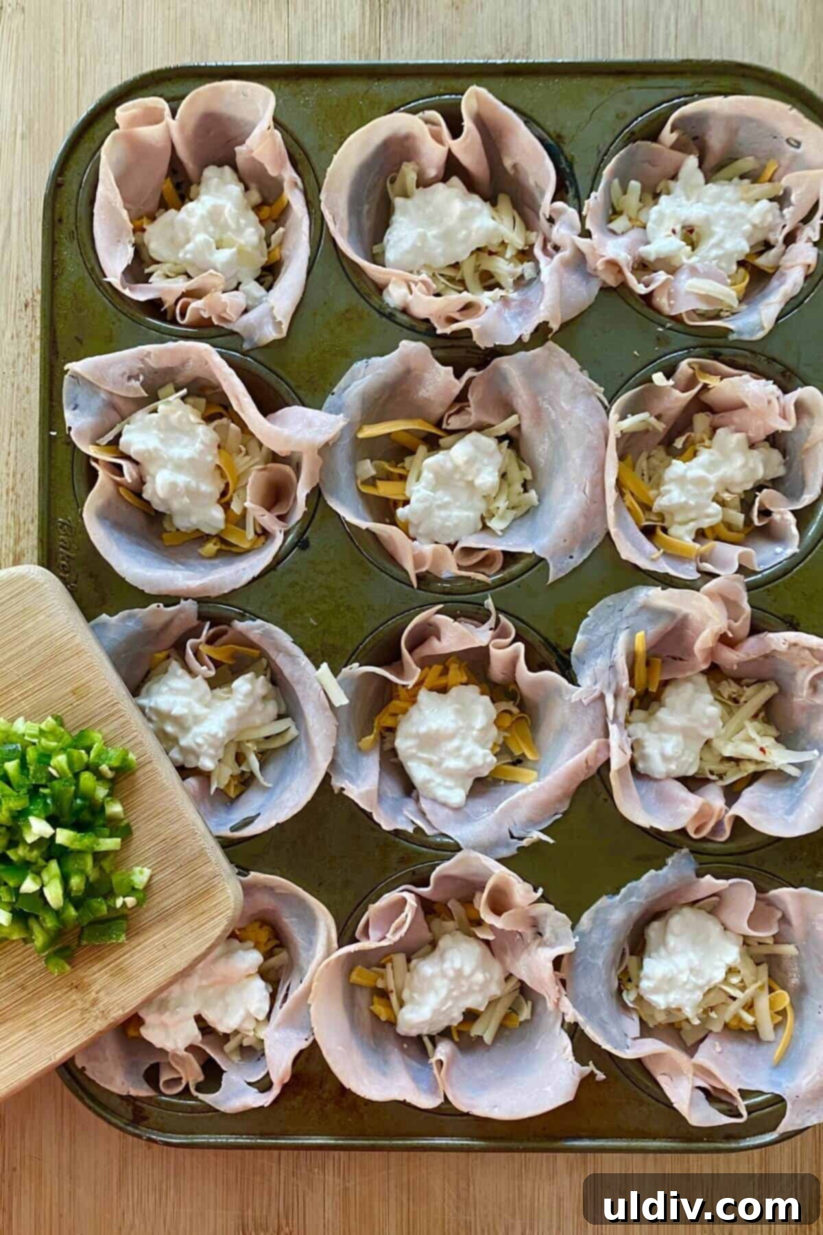 Cheesy Jalapeno Egg Popper Bites 5 ham cups with 3 cheeses and chopped jalapeno.