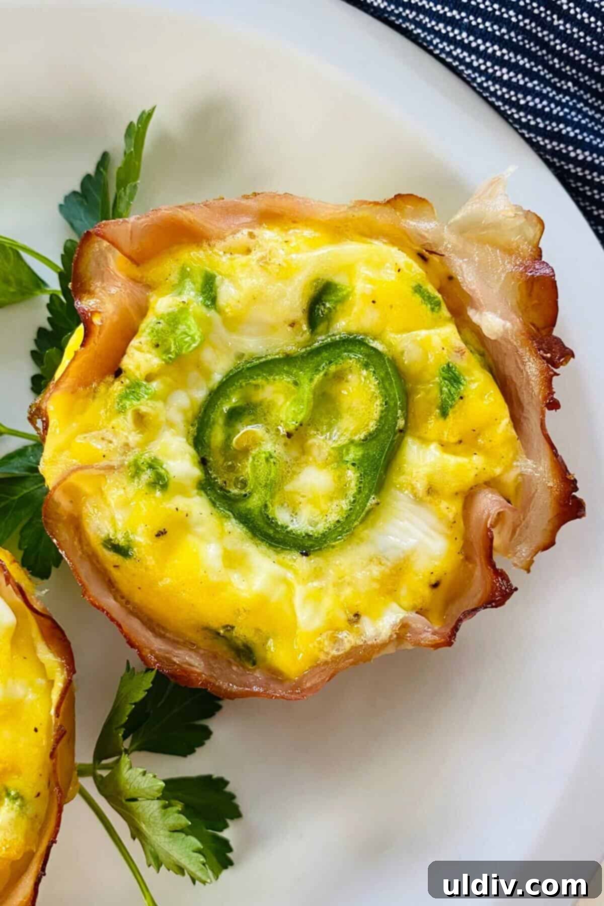 Fiery Popper Breakfast Bites 8 a single jalapeno popper egg cup on a plate.