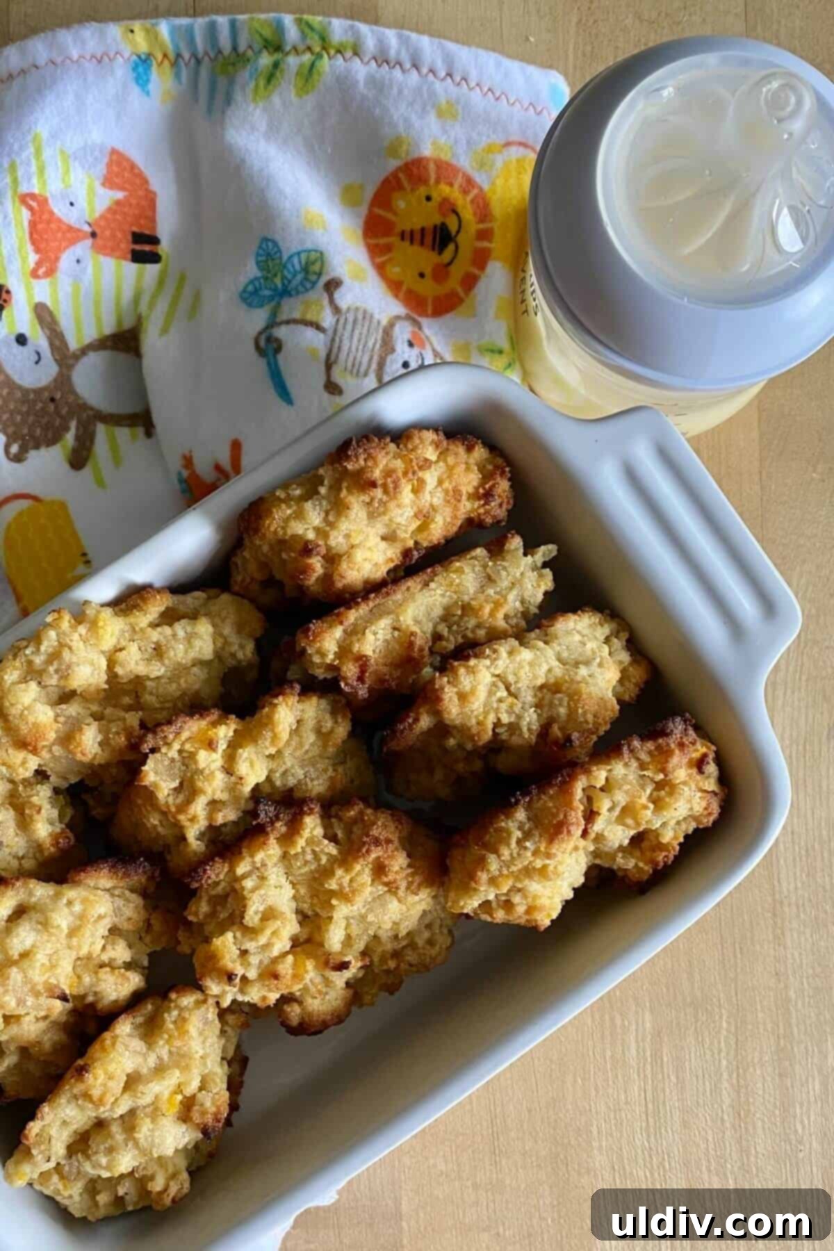 The Best Breastfeeding Lactation Cookie Recipe 8 A baby bottle next to a stack of lactation cookies, symbolizing nourishment for both mother and child.