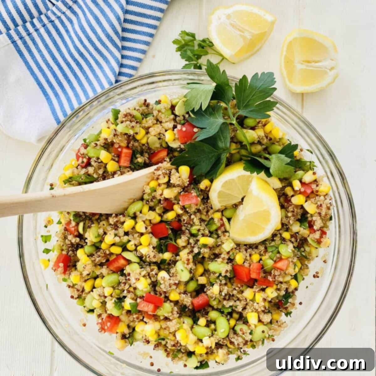 bowl of quinoa salad with wooden spoon.