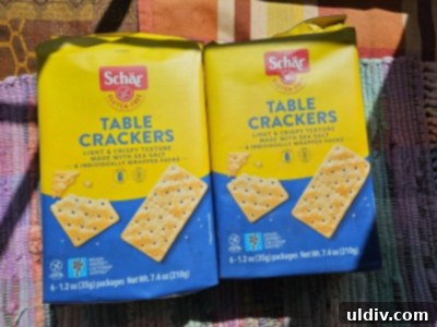 May's Top Product Picks 3 Schär Gluten Free Table Crackers on a white background, highlighting their light and crispy texture.