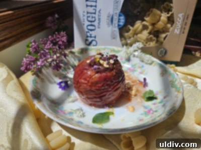 Sfoglini Reimagined 7 Close-up of a beautifully presented baked apple with Sfoglini Zucca pasta, garnished with edible flowers and mint, ready to be enjoyed