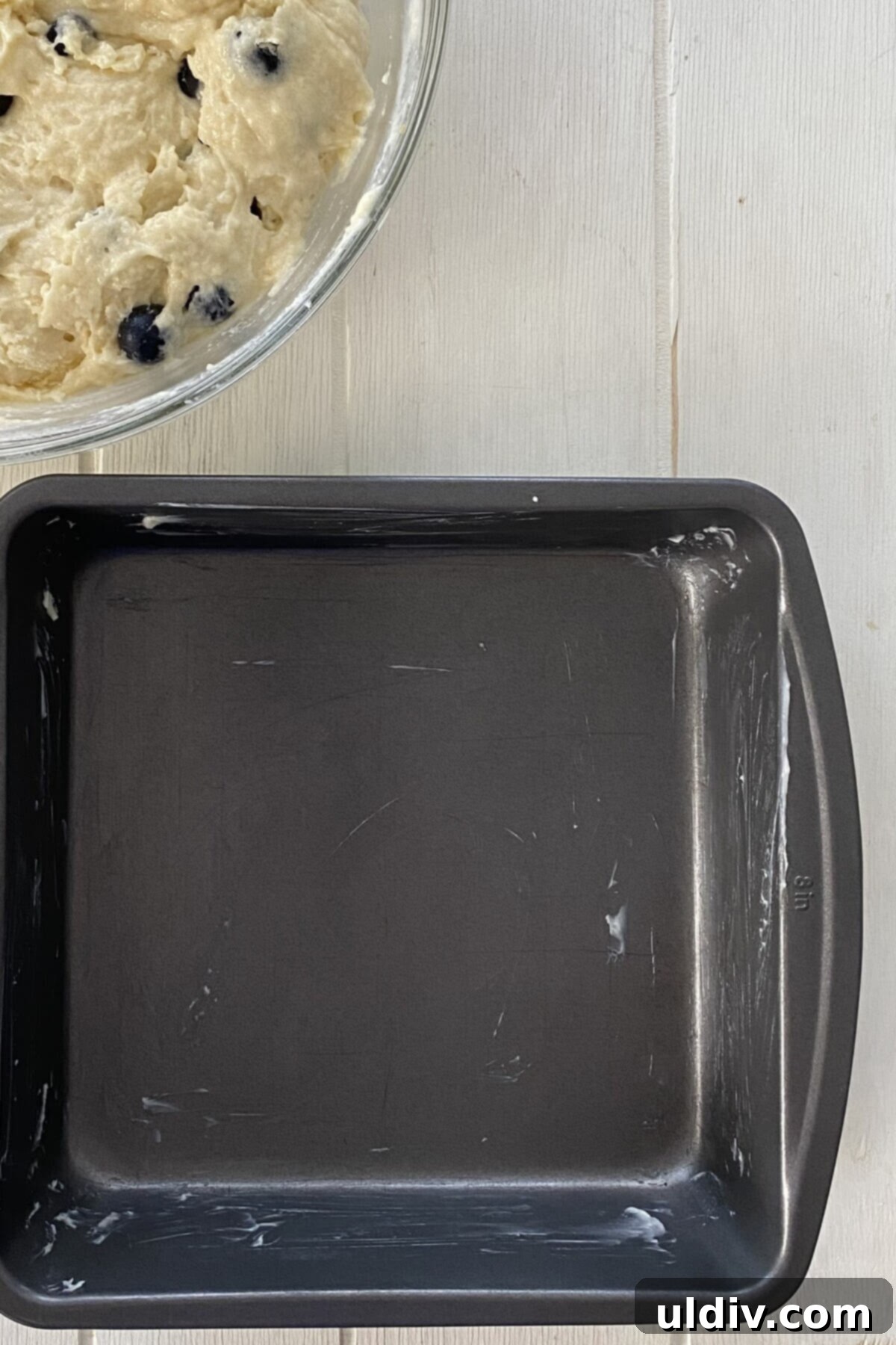 Bursting Blueberry Muffin Cake 4 A greased 8x8 inch baking pan, ready for the cake batter.
