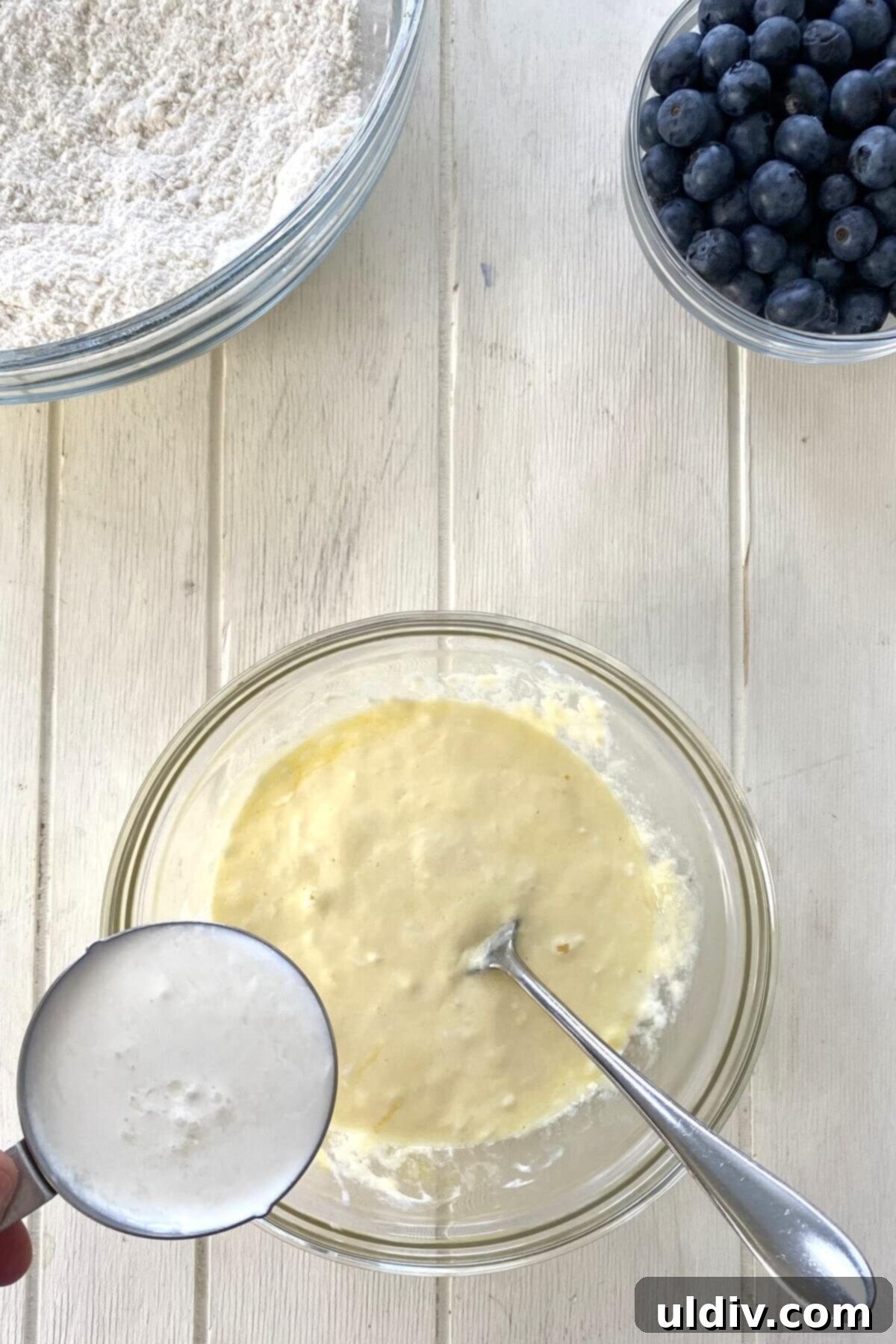 The wet ingredients for the muffin cake batter, smoothly combined in a medium bowl.