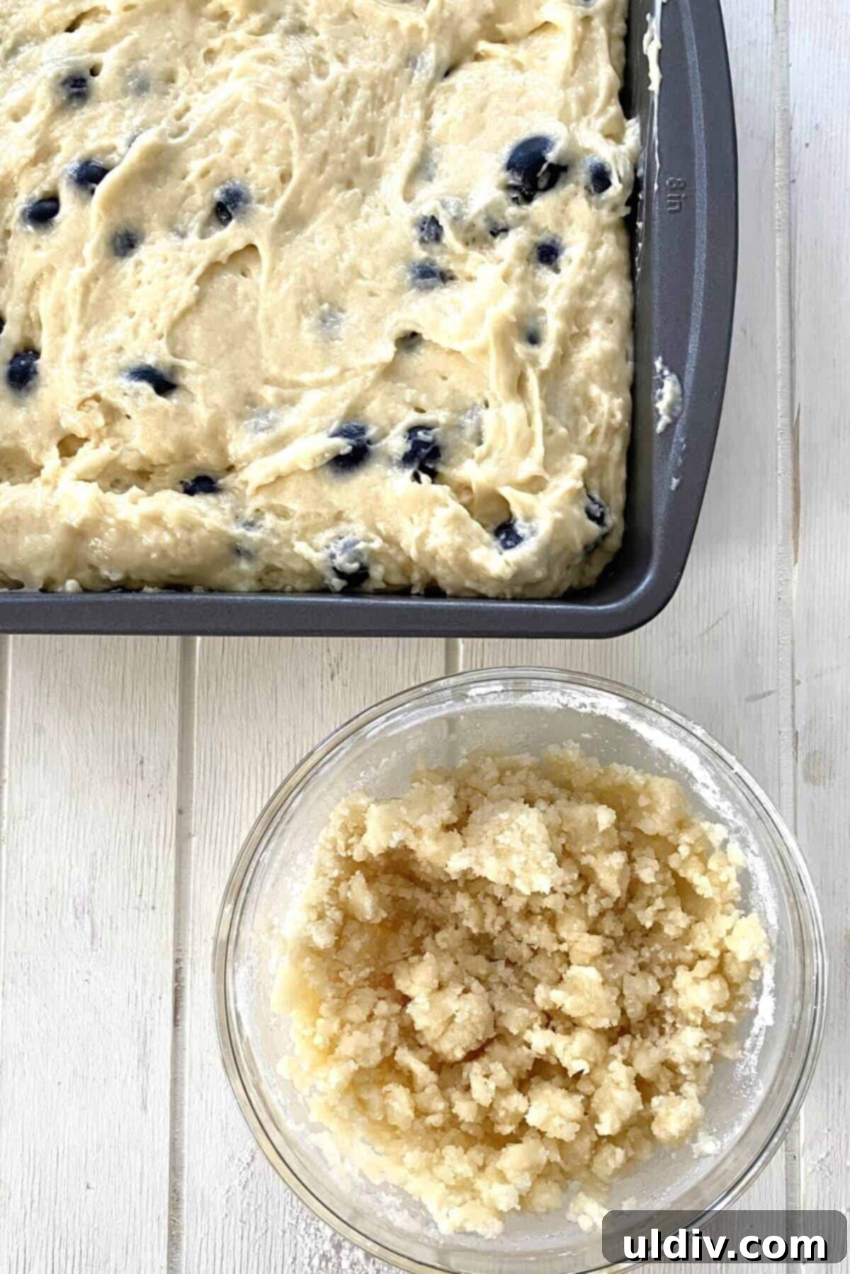 Bursting Blueberry Muffin Cake 8 Spreading the cake batter into the greased baking pan.