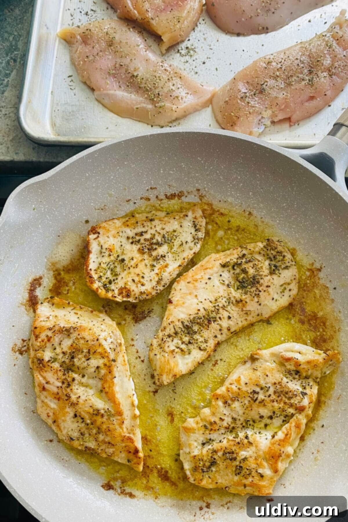 Sautéing chicken in a large skillet for low carb chicken parmesan.