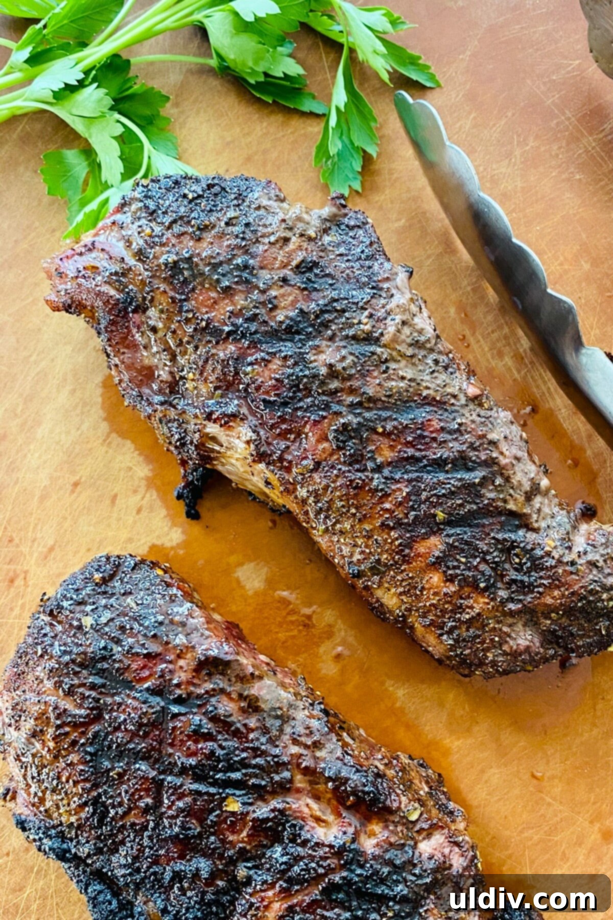Tender Smoky Coffee Rubbed Steak 11 Two grilled steaks, one whole and one sliced, showcasing a perfect crust.